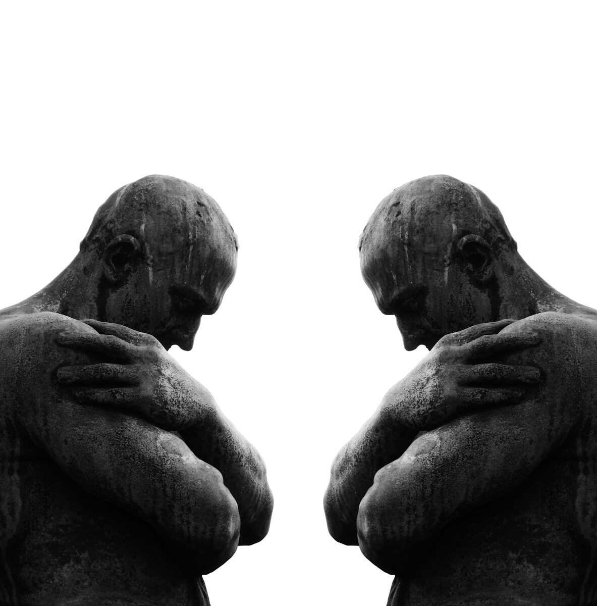 a statue of a man holding his hands to his chest
